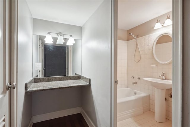 bathroom featuring tile floors, tile walls, and tiled shower / bath combo