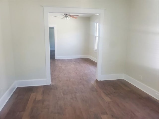 empty room with ceiling fan and dark hardwood / wood-style floors