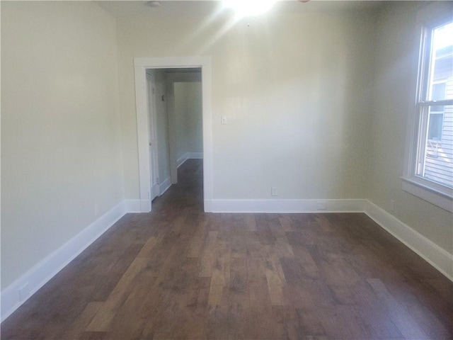 empty room with dark wood-type flooring