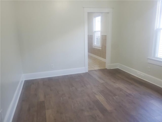 empty room featuring dark hardwood / wood-style flooring