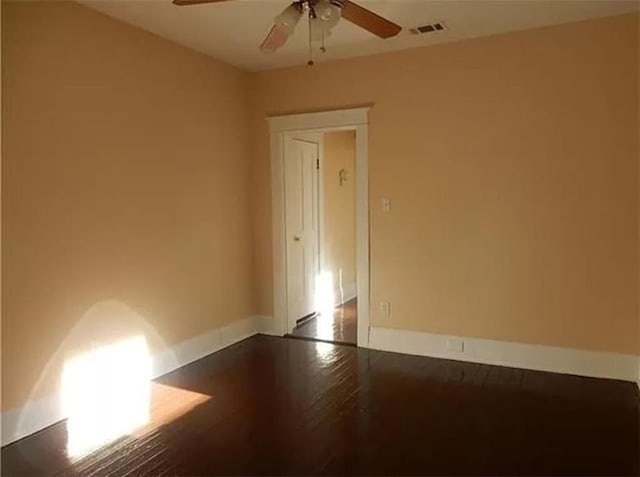 empty room with hardwood / wood-style flooring and ceiling fan