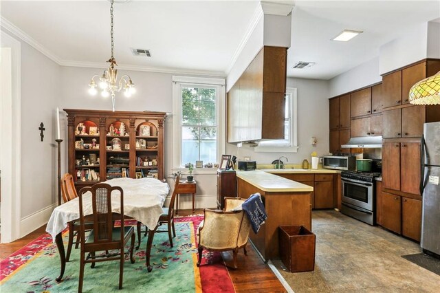 kitchen with a notable chandelier, light tile patterned flooring, stainless steel appliances, hanging light fixtures, and crown molding