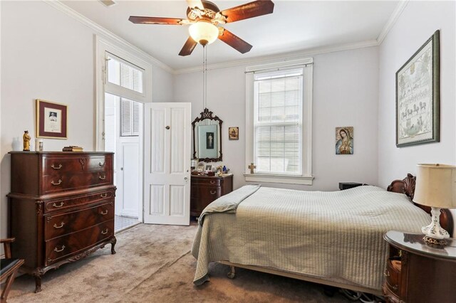 bedroom featuring crown molding, light carpet, multiple windows, and ceiling fan