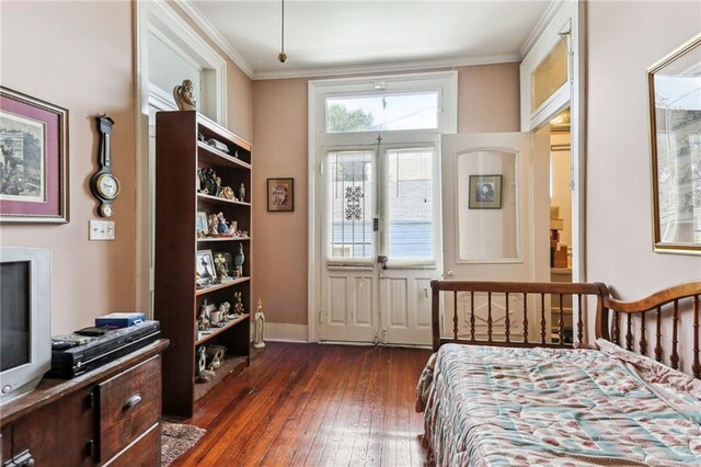 bedroom featuring dark hardwood / wood-style floors, french doors, and ornamental molding