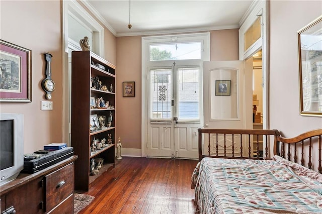 bedroom featuring crown molding and dark wood-type flooring