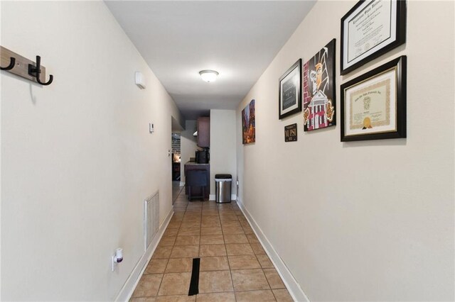 hall featuring light tile patterned flooring