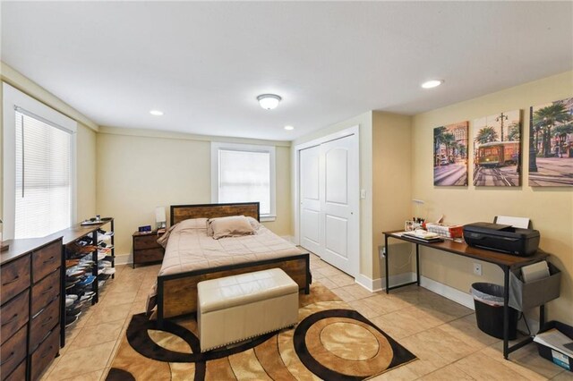 tiled bedroom featuring a closet