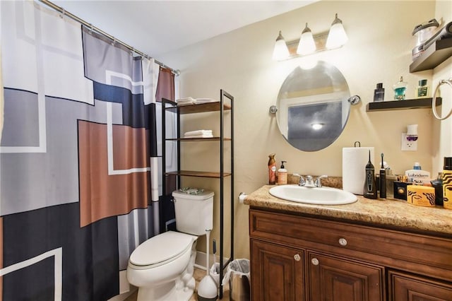 bathroom with toilet, vanity, and curtained shower