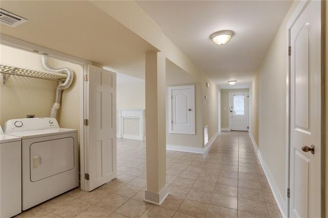 laundry room featuring washer and dryer and light tile patterned floors