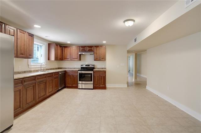 kitchen with light tile patterned flooring, stainless steel appliances, and sink