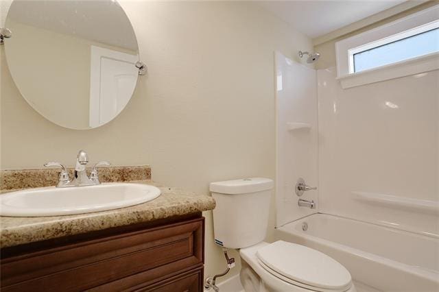 full bathroom with  shower combination, vanity, and toilet