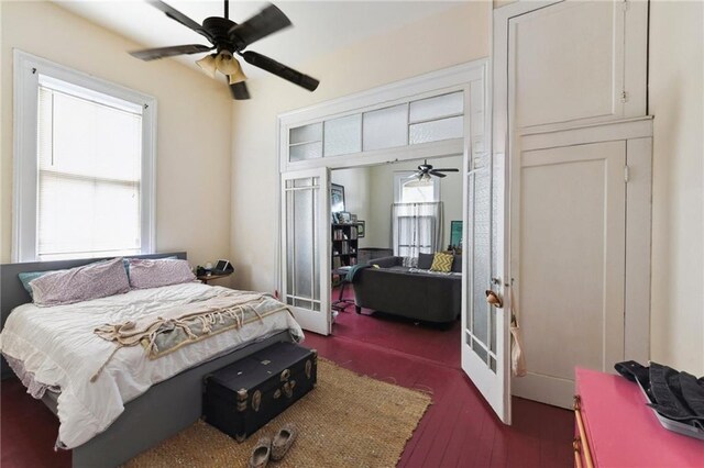 bedroom with wood-type flooring, french doors, and ceiling fan