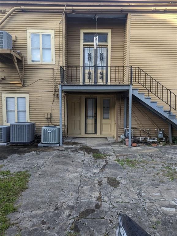 rear view of property with central AC and a patio