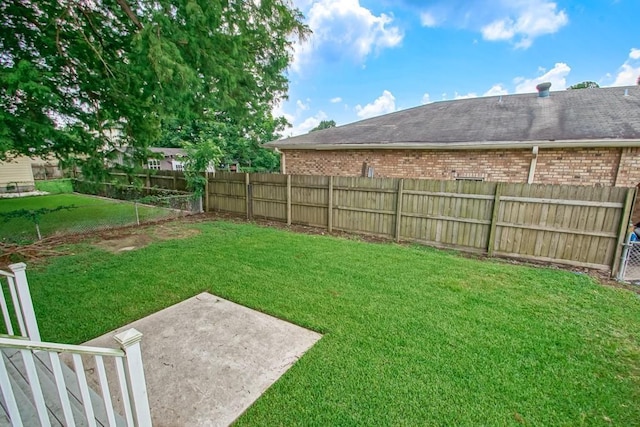 view of yard with a fenced backyard