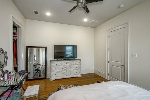 bedroom with recessed lighting, wood finished floors, visible vents, and baseboards