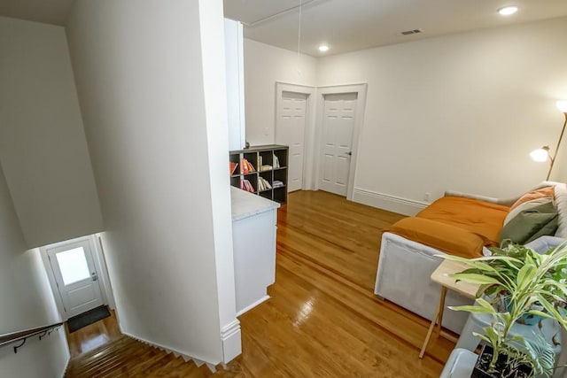 corridor with hardwood / wood-style floors