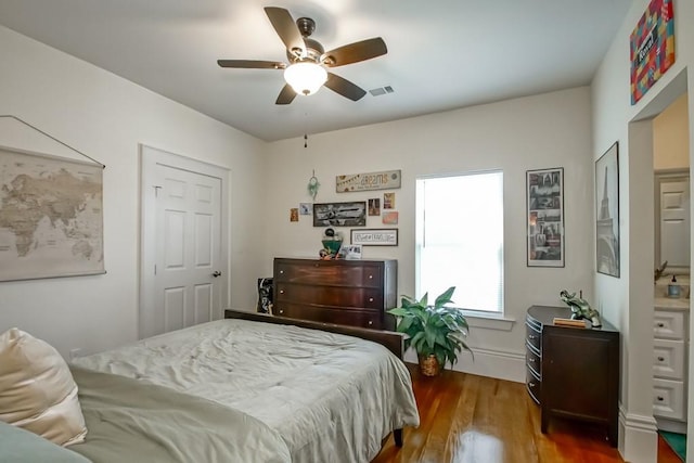 bedroom featuring visible vents, wood finished floors, and a ceiling fan