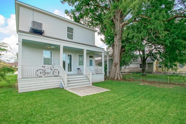 view of front of home with a front lawn, fence, and covered porch