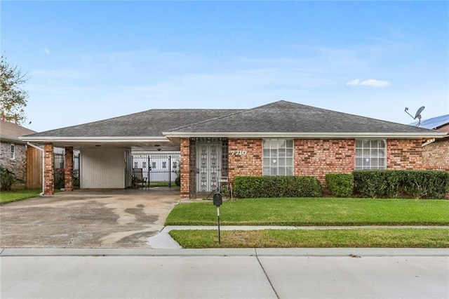 single story home featuring a carport and a front lawn