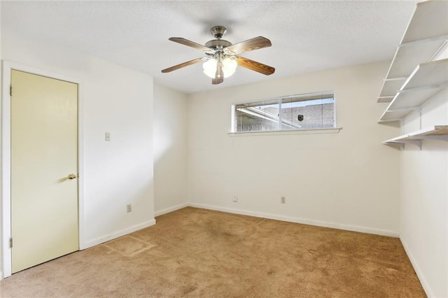 unfurnished room with ceiling fan and light carpet