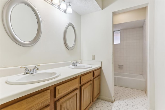 bathroom with vanity and tiled shower / bath