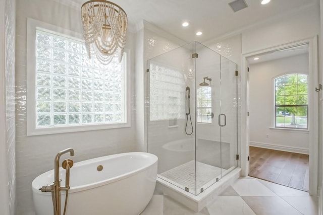 bathroom with independent shower and bath, tile patterned flooring, a healthy amount of sunlight, and ornamental molding