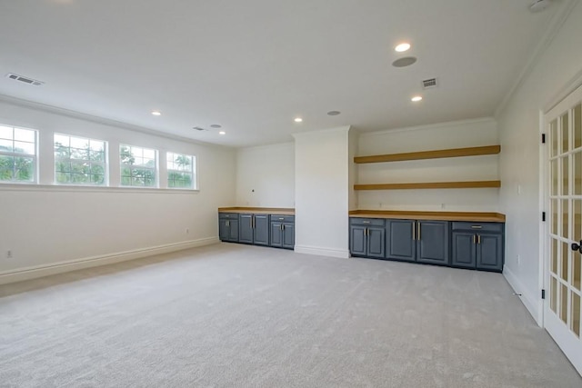 interior space featuring light carpet and crown molding