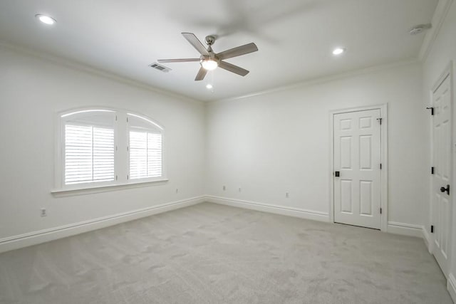 empty room with light colored carpet, ceiling fan, and ornamental molding