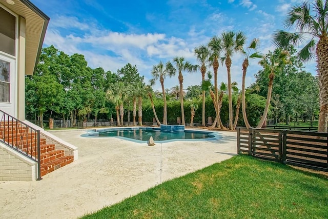 view of swimming pool featuring a yard and a patio