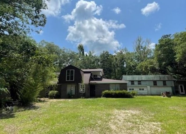 rear view of property featuring a yard