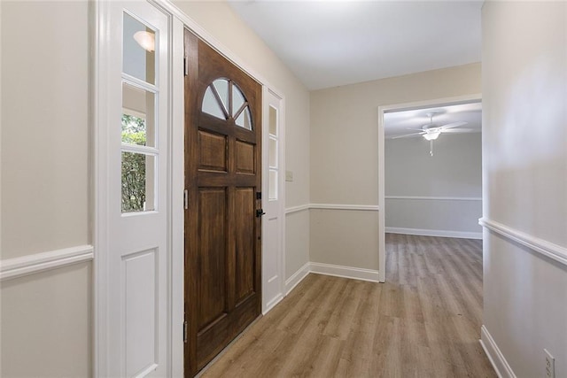 foyer with ceiling fan and light hardwood / wood-style flooring