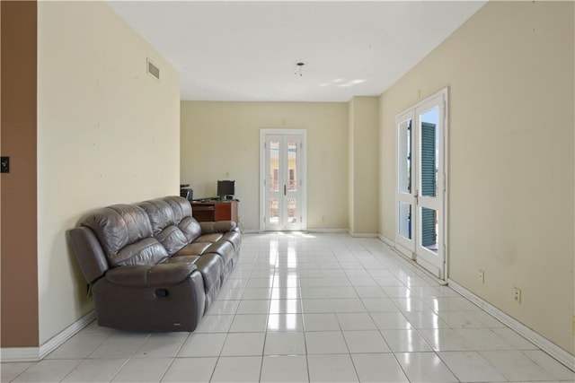 living room with light tile patterned floors and french doors