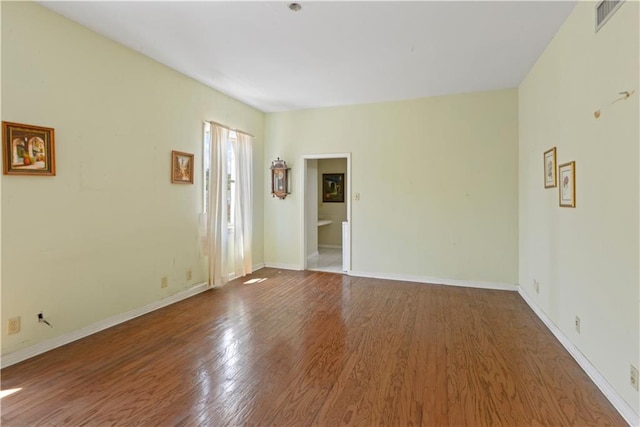 spare room featuring wood-type flooring