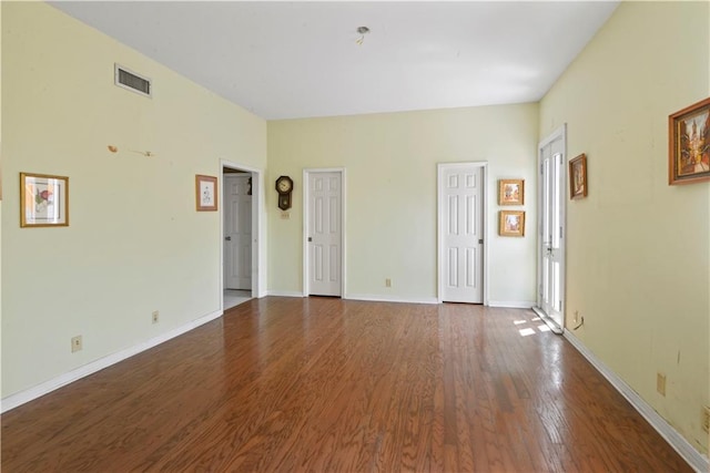 unfurnished room featuring hardwood / wood-style flooring