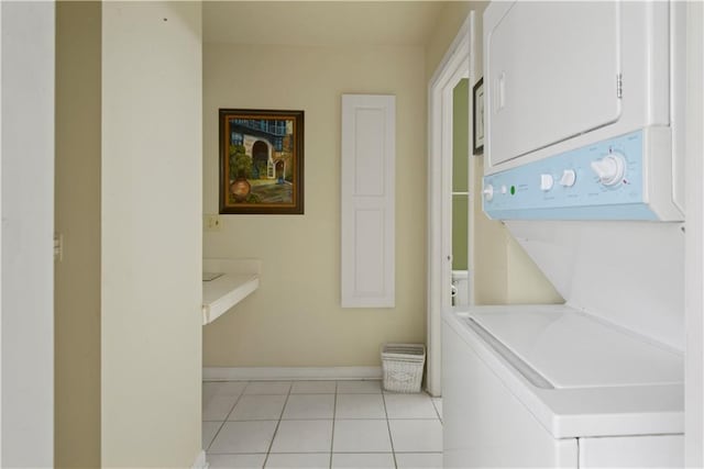 laundry room with stacked washing maching and dryer and light tile patterned floors