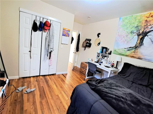 bedroom with a closet and hardwood / wood-style flooring