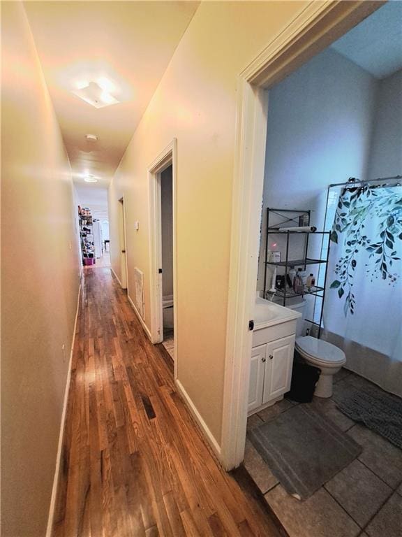 hallway featuring dark hardwood / wood-style flooring