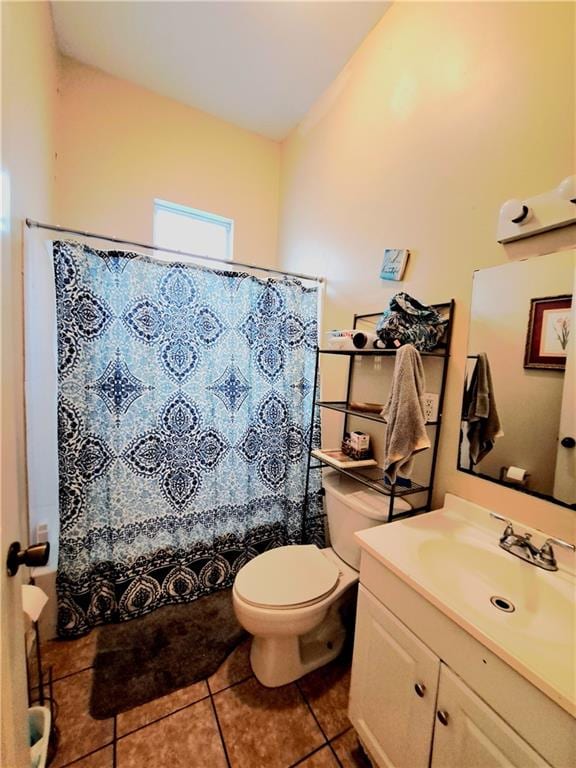 bathroom featuring tile flooring, toilet, and vanity