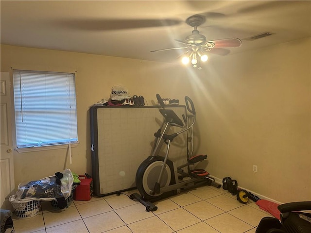 exercise area featuring ceiling fan and light tile floors