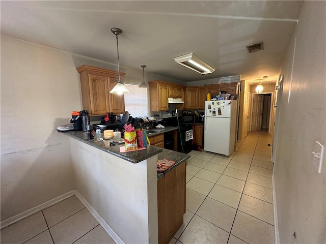 kitchen featuring kitchen peninsula, white refrigerator, decorative light fixtures, stove, and light tile floors