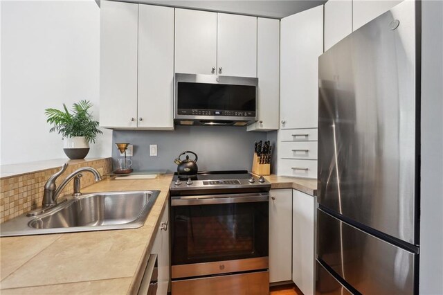 kitchen with white cabinets, sink, and appliances with stainless steel finishes