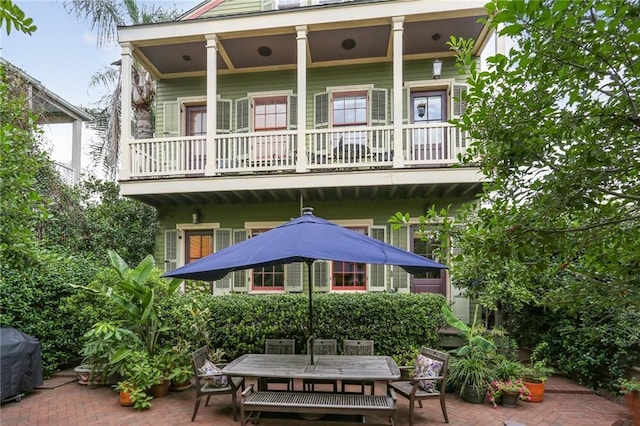 back of house with a patio area and a balcony