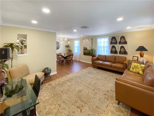 living room with recessed lighting, wood finished floors, visible vents, baseboards, and ornamental molding