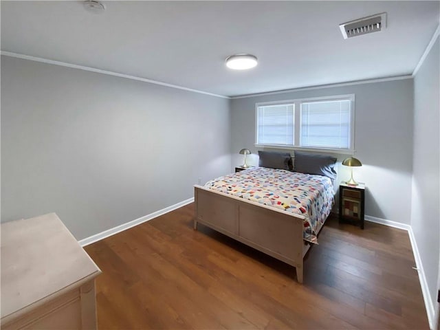 bedroom with dark wood-style floors, baseboards, visible vents, and crown molding