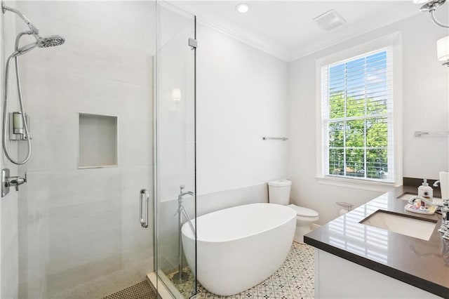 bathroom with a shower stall, a freestanding bath, toilet, ornamental molding, and vanity