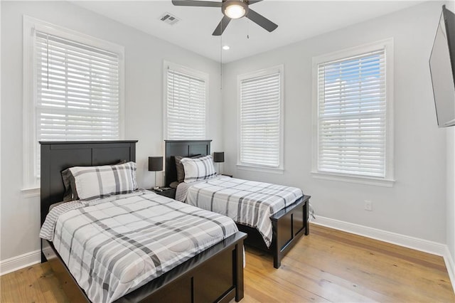 bedroom featuring visible vents, a ceiling fan, recessed lighting, light wood-style floors, and baseboards