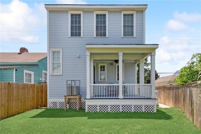 view of front facade with a fenced backyard, covered porch, a front yard, and ceiling fan