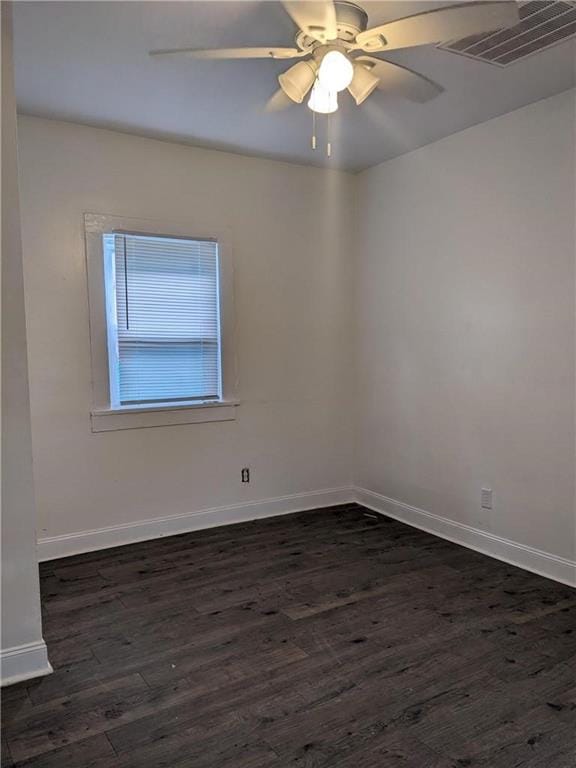 unfurnished room with ceiling fan and dark hardwood / wood-style flooring