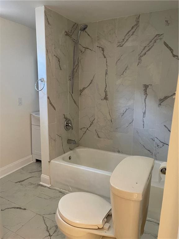 bathroom featuring tiled shower / bath and toilet