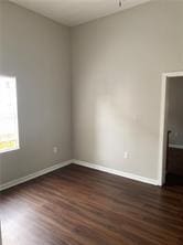 empty room with dark hardwood / wood-style floors